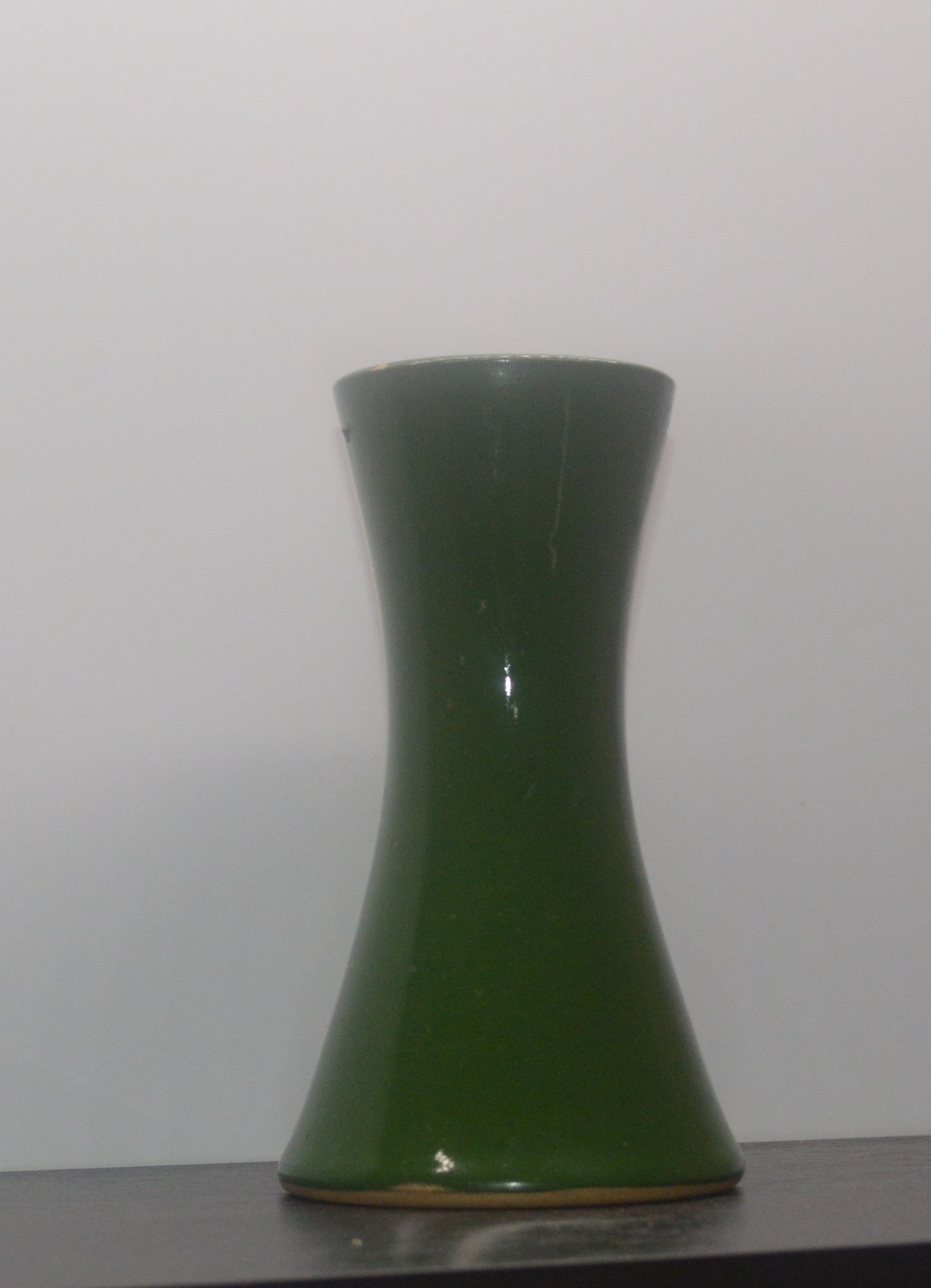 Mid-century Denby Bourne green vase with glossy finish, lying on its side
