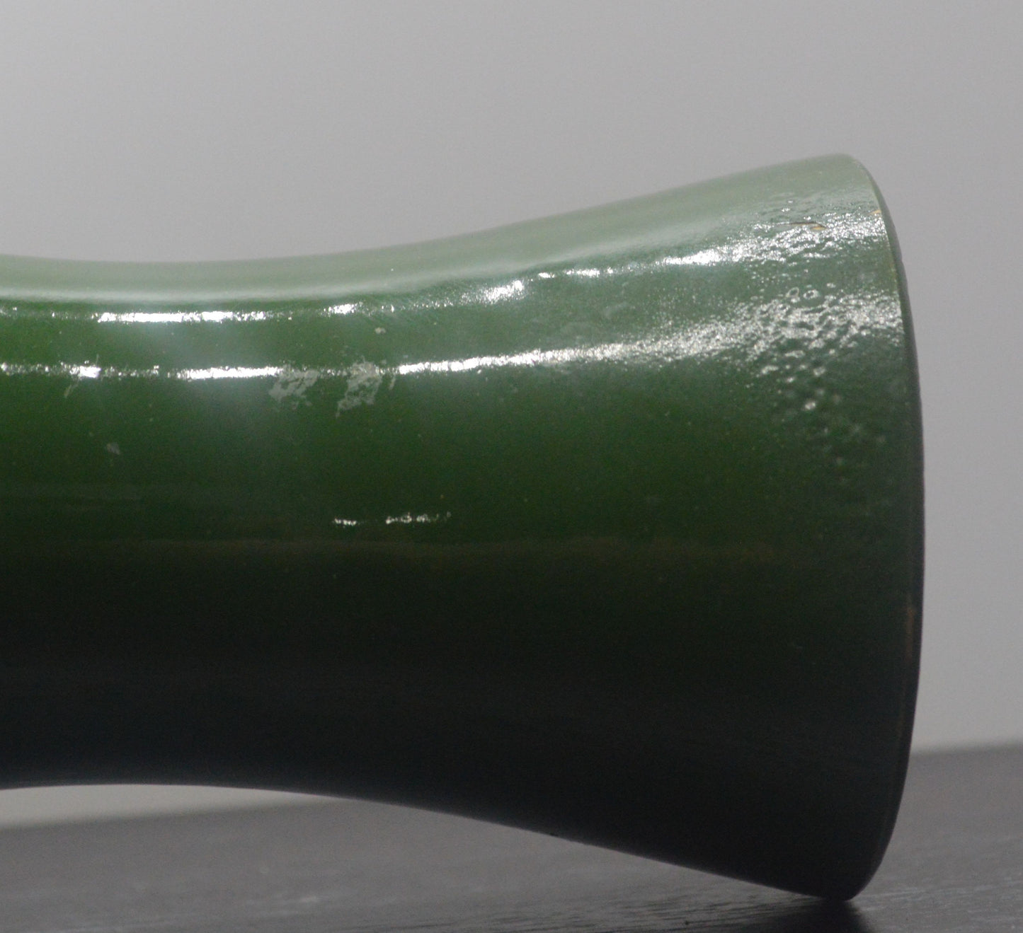 op view of Denby green vase showing interior and chip on the rim.