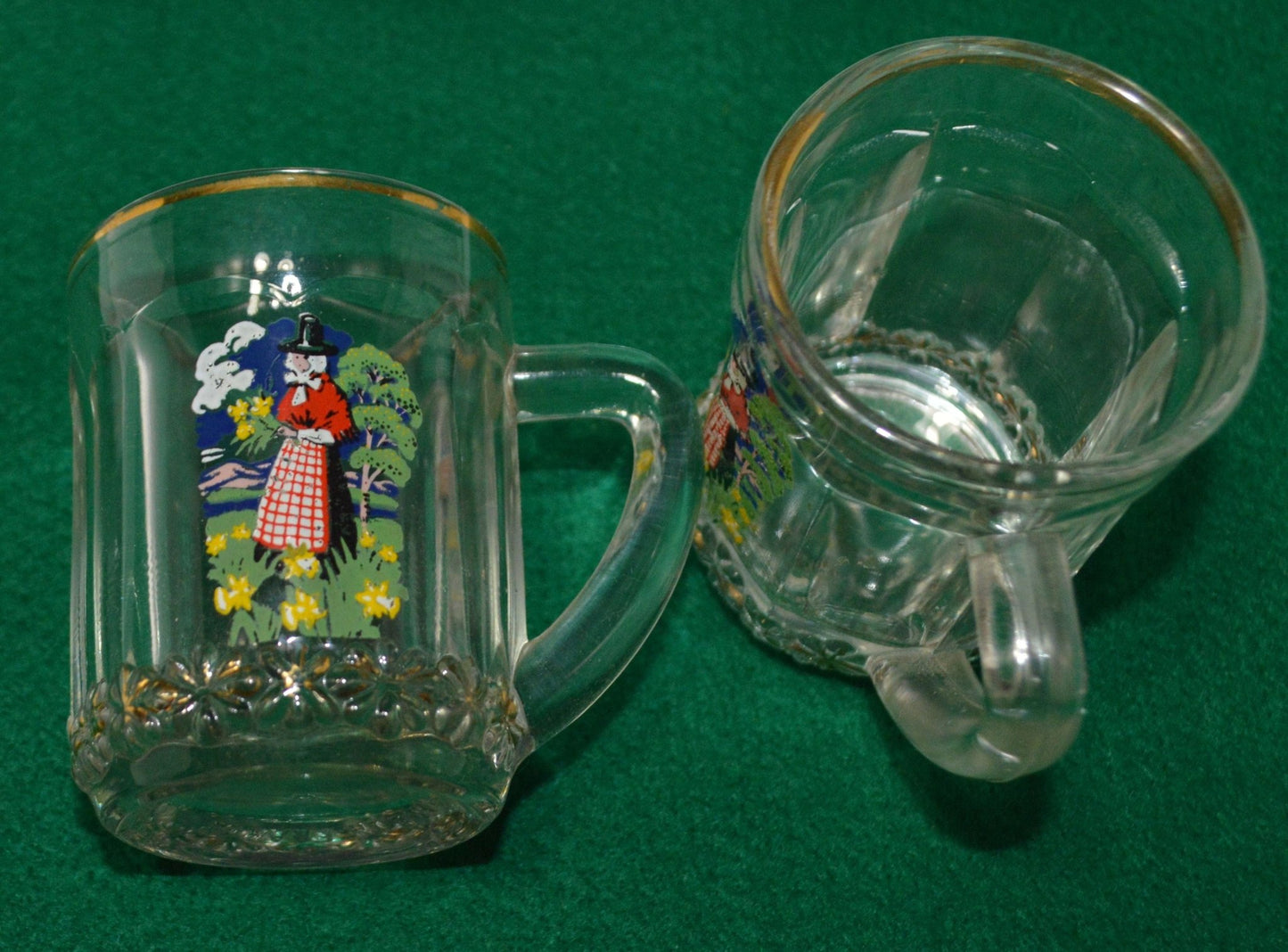 TWO MINIATURE GLASS TANKARDS DEPICTING THE TRADITIONAL COSTUME OF A WELSH LADY(PREVIOUSLY OWNED) GOOD CONDITION - TMD167207