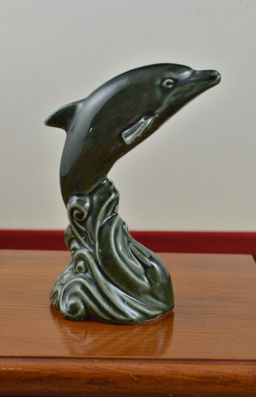 Vintage green ceramic dolphin figurine jumping over stylised wave base decorative ornament