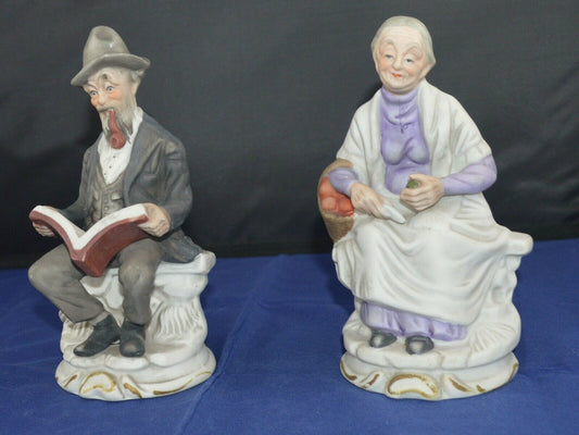 DECORATIVE FIGURINES MAN SITTING READING & A LADY IN A LILAC DRESS(PREVIOUSLY OWNED) GOOD CONDITION - TMD167207