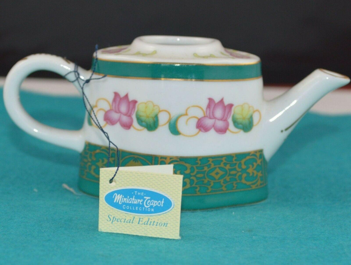 PORCELAIN ART THE MINIATURE TEAPOT COLLECTION WITH GREEN LID AND PINK FLOWERS HAS TAG(PREVIOUSLY OWNED)  - TMD167207