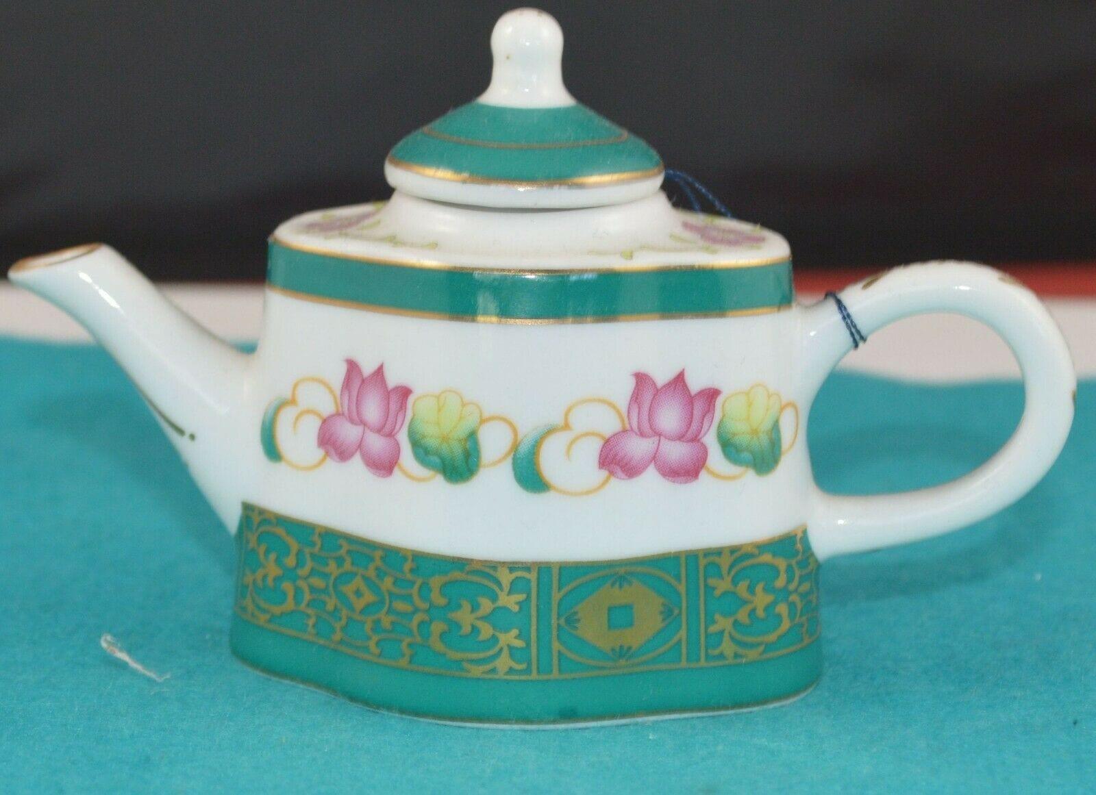 PORCELAIN ART THE MINIATURE TEAPOT COLLECTION WITH GREEN LID AND PINK FLOWERS HAS TAG(PREVIOUSLY OWNED) - TMD167207