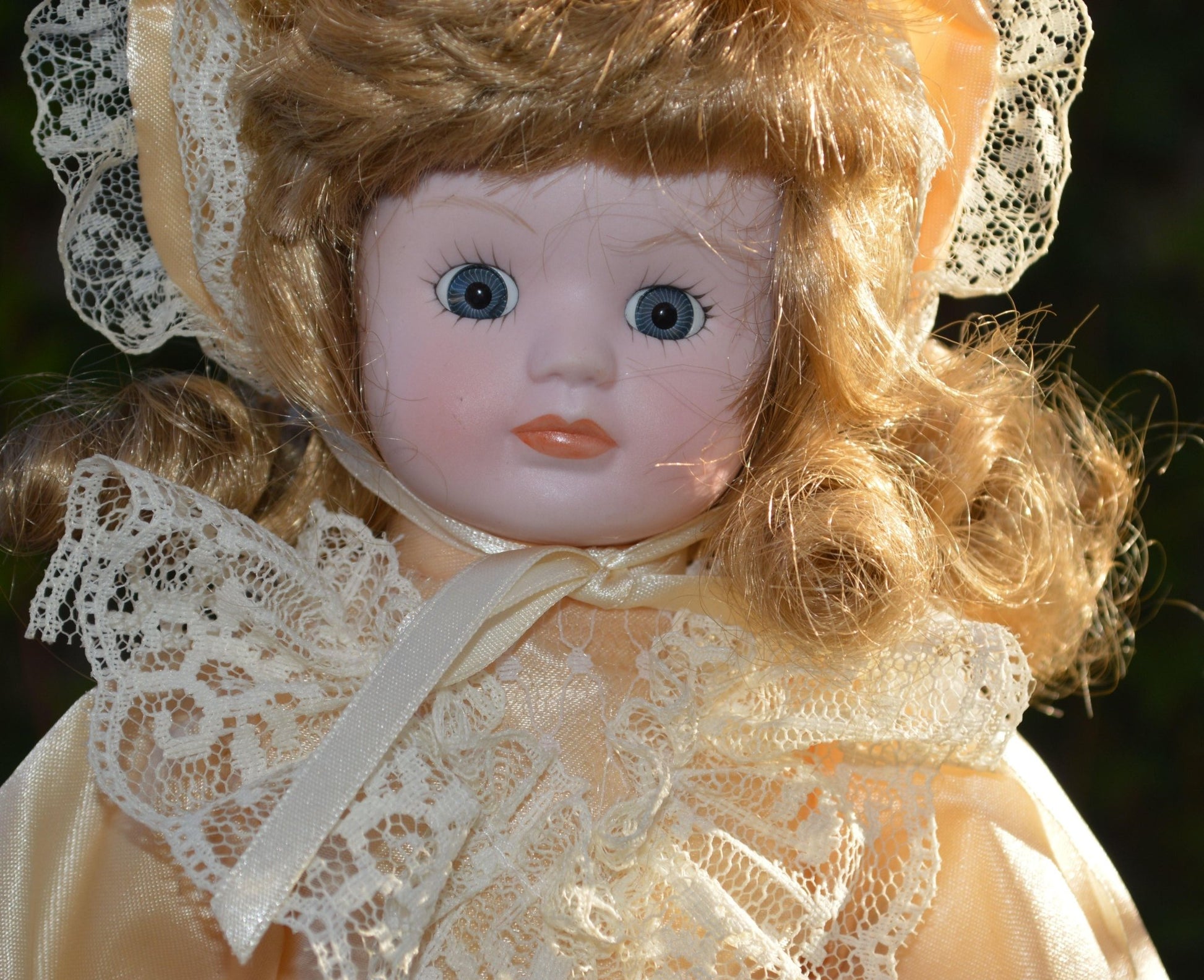 PORCELAIN DOLL IN A LIGHT PEACH DRESS
