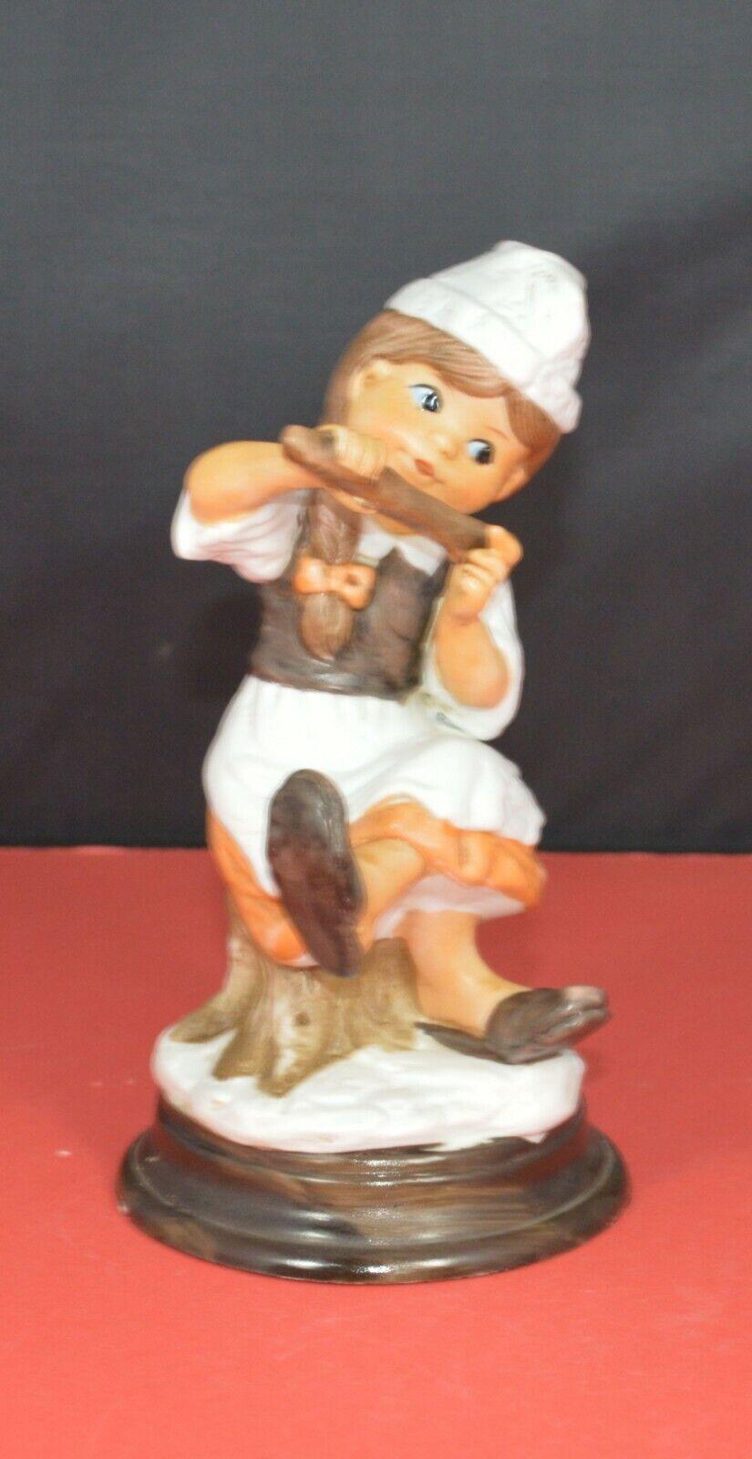 TWO DIFFERENT DECORATIVE FIGURINES OF A YOUNG COOK SITTING ON A TREE STUMP - TMD167207