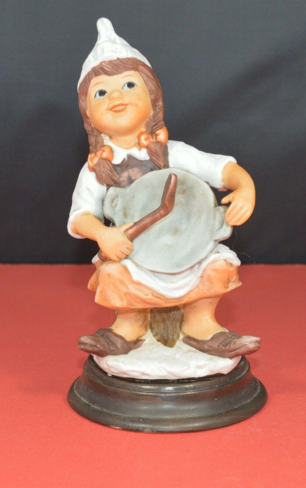 TWO DIFFERENT DECORATIVE FIGURINES OF A YOUNG COOK SITTING ON A TREE STUMP - TMD167207