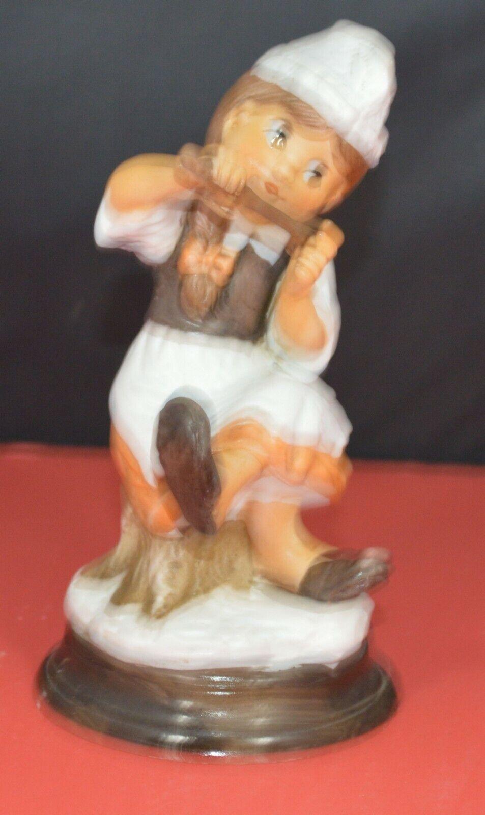TWO DIFFERENT DECORATIVE FIGURINES OF A YOUNG COOK SITTING ON A TREE STUMP - TMD167207