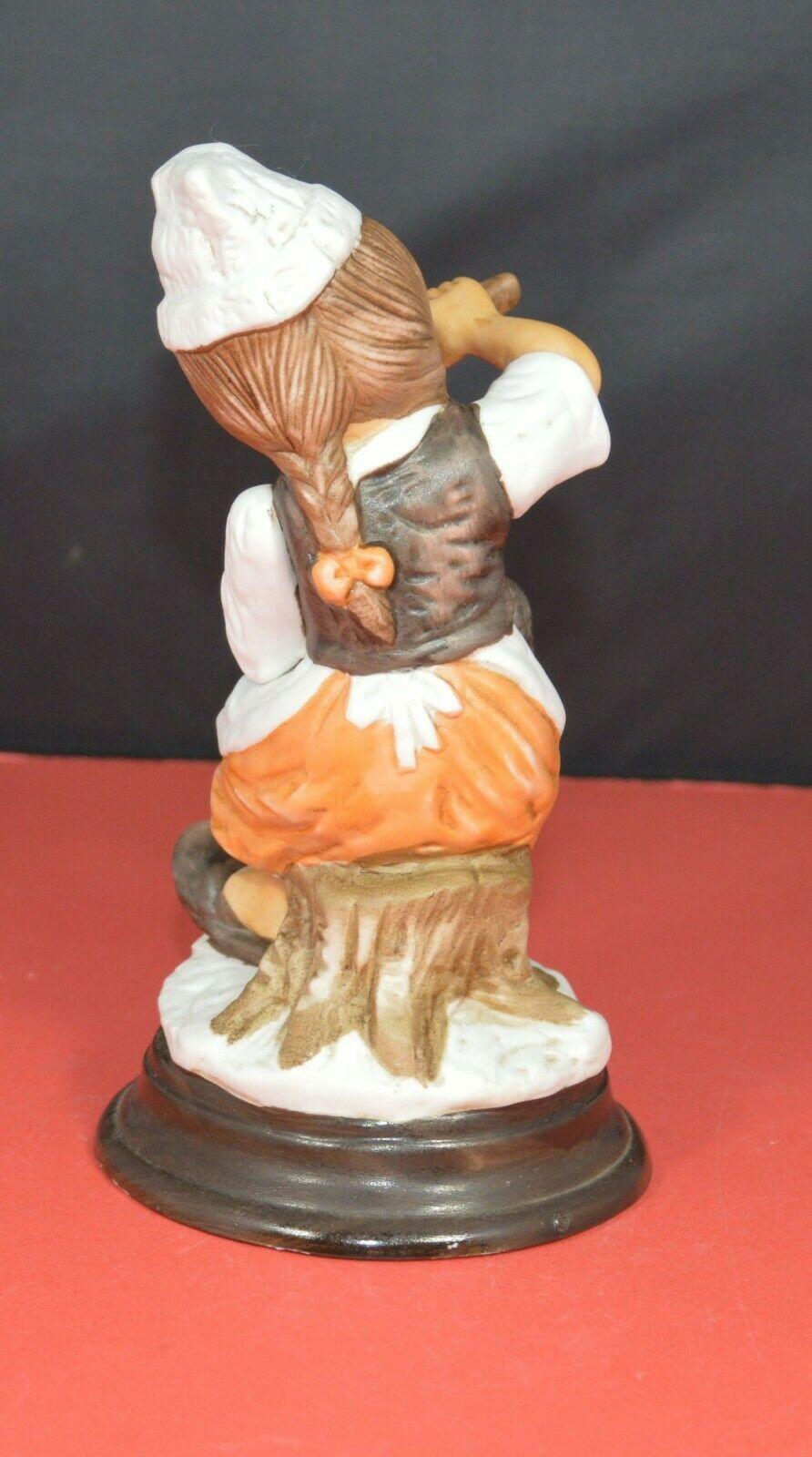 TWO DIFFERENT DECORATIVE FIGURINES OF A YOUNG COOK SITTING ON A TREE STUMP - TMD167207
