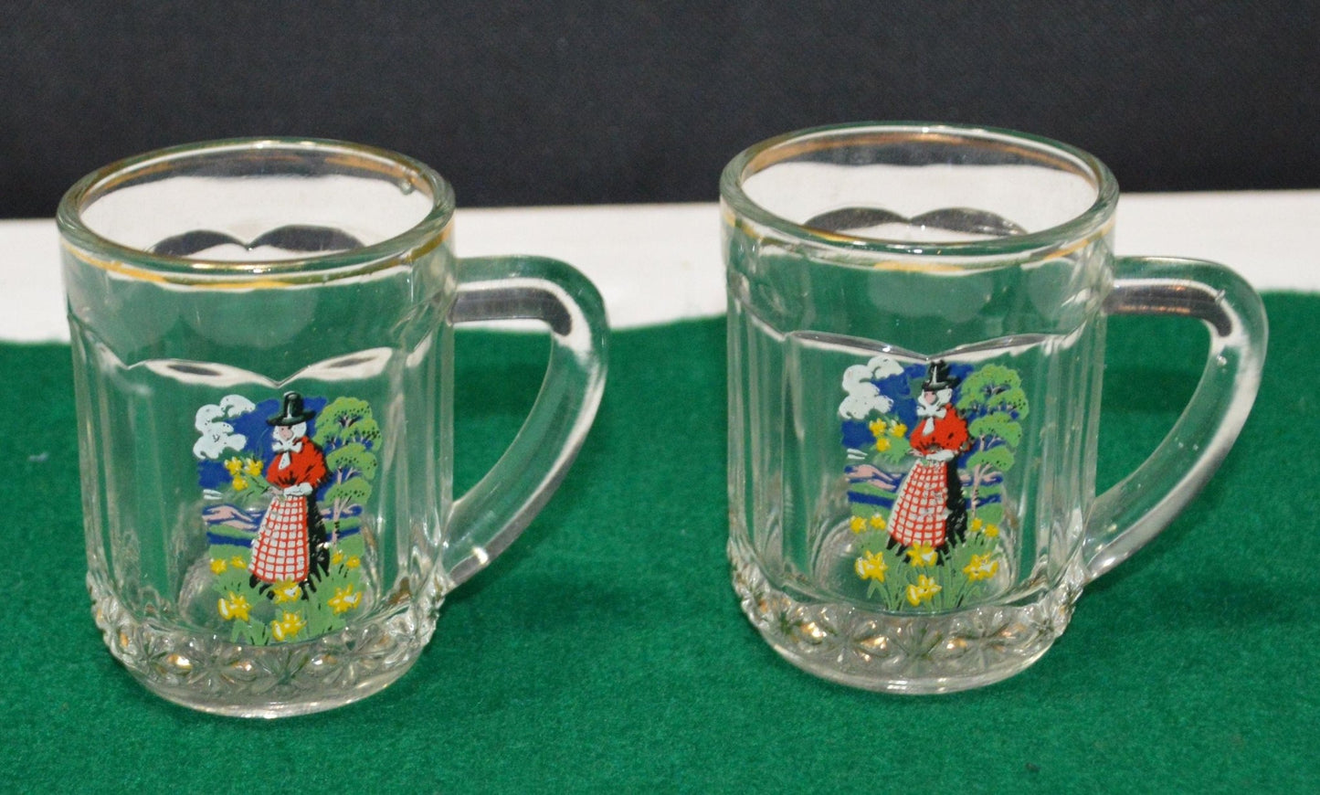 TWO MINIATURE GLASS TANKARDS DEPICTING THE TRADITIONAL COSTUME OF A WELSH LADY(PREVIOUSLY OWNED) GOOD CONDITION - TMD167207